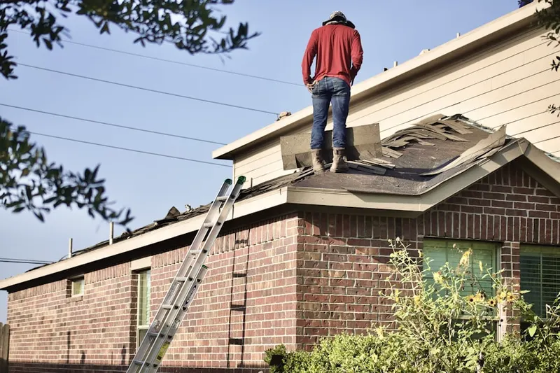 Professional roofer working on a residential roof in Arlington Ridge